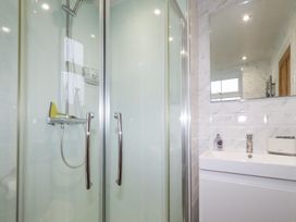 A bathroom with a shower and sink at Riverside Cottage in Warkworth