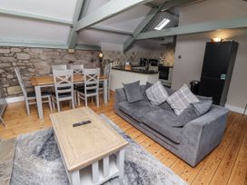A living room with a dining table and a sofa at Old Mill (Lucker) Lucker