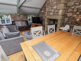 A living room with a sofa and television at Old Mill (Lucker) Lucker