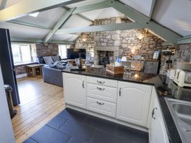 A kitchen with an island and dining table at The Old Mill (Lucker) in Lucker