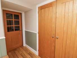 A hallway with wooden doors and a closet at Old Mill (Lucker)