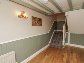 A hallway with a staircase and map at Old Mill (Lucker)