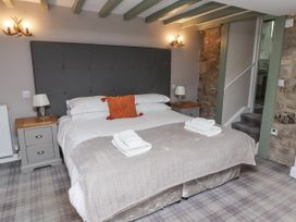 A bedroom with a bed and nightstands at Old Mill (Lucker) Lucker