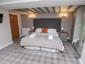 A bedroom with a bed and nightstands at Old Mill (Lucker) Lucker