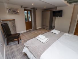 A bedroom with a bed and a wardrobe at Old Mill (Lucker) Lucker