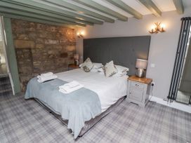 A bedroom with a bed and a bedside table at Old Mill (Lucker) Lucker