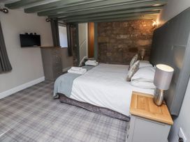 A bedroom with a bed and dresser at Old Mill in Lucker