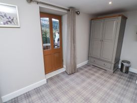 A room with a wardrobe and door at Old Mill (Lucker) Lucker