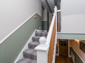 A staircase with a handrail in a hallway at Old Mill (Lucker) Lucker