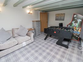 A game room with a foosball table and sofa at Old Mill in Lucker