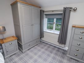 A bedroom with furniture including wardrobe and nightstand at Old Mill (Lucker) in Lucker