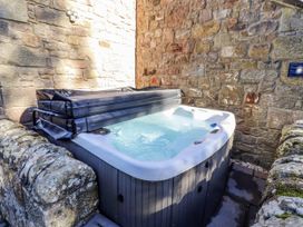 A hot tub with a cover in an outdoor area at Old Mill (Lucker)
