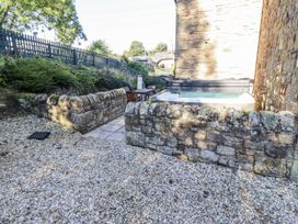 A garden with a hot tub and seating area at Old Mill (Lucker) Lucker