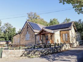 A building with solar panels and seating area at Old Mill (Lucker) Lucker