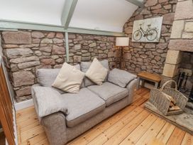 A living room with a sofa and a side table at Millstone in Lucker