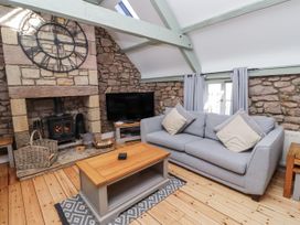 A living room with a sofa and fireplace at Millstone in Lucker