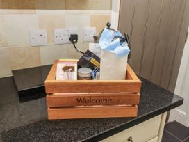 A welcome basket with paper towels and food items on a counter at Millstone in Lucker