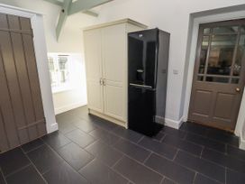 A kitchen with a refrigerator and storage cabinet at Millstone in Lucker