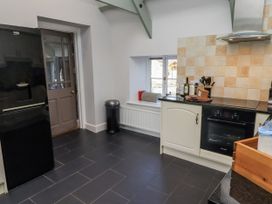 A kitchen with a refrigerator and oven at Millstone in Lucker