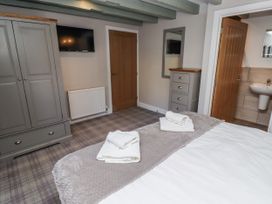 A bedroom with a bed and wardrobe at Millstone in Lucker