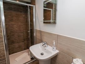 A bathroom with a shower and sink at Millstone in Lucker