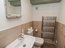 A bathroom with a sink and toilet at Millstone in Lucker
