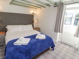 A bedroom with a bed and bedside table at Millstone in Lucker