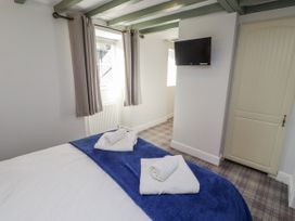 A bedroom with a bed and television at Millstone in Lucker