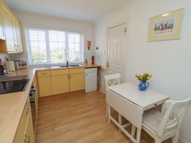 A kitchen with a sink and table at 6 Westview in Embleton