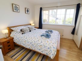 A bedroom with a bed and nightstands at 6 Westview in Embleton