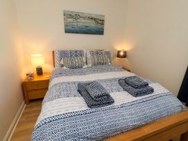 A bedroom with a bed and bedside table at 6 Westview in Embleton