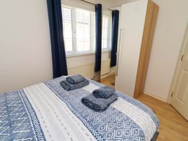 A bedroom with a bed and wardrobe at 6 Westview in Embleton