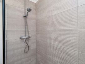A shower with chrome fixtures and tiled walls at 6 Westview Embleton