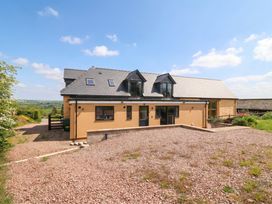 A house with multiple windows and driveway at Palace Farmhouse St Weonards