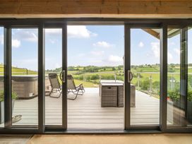 A balcony with outdoor furniture and a hot tub at Bwncath in Garthmyl