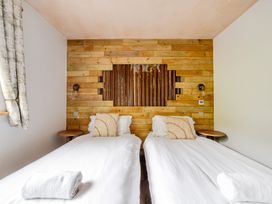 A bedroom with two single beds at Bwncath in Garthmyl