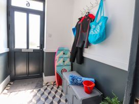 A hallway with a wetsuit and beach gear at Ty Haul in Rhosneigr