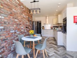 A kitchen with a table and chairs at Ty Haul in Rhosneigr
