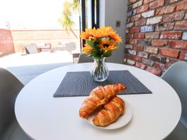 A dining room with a table and croissants at Ty Haul in Rhosneigr