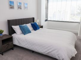 A bedroom with a bed and nightstand at Ty Haul in Rhosneigr