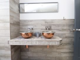 A bathroom with double sinks and a mirror at Ty Haul in Rhosneigr