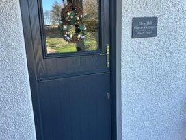 A door with a wreath and a sign at How Hill Farm Cottage in Greystoke