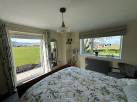 A bedroom with a bed and window at How Hill Farm Cottage Greystoke