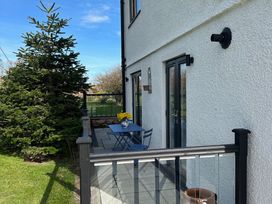 An outdoor area with a table and chairs at How Hill Farm Cottage in Greystoke