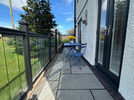An outdoor area with a table and chairs at How Hill Farm Cottage in Greystoke