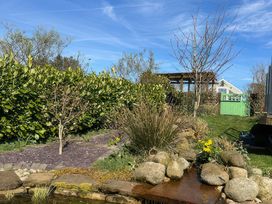 A garden with a pond and plants at How Hill Farm Cottage in Greystoke