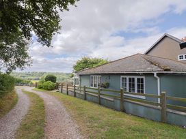 A house with a pathway and trees at Rainbow View in Churchstanton near Churchinford
