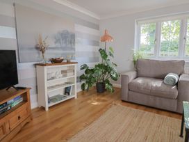 A living room with a plant and a chair at Rainbow View Churchstanton near Churchinford