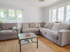 A living room with a sectional sofa and coffee table at Rainbow View in Churchstanton near Churchinford