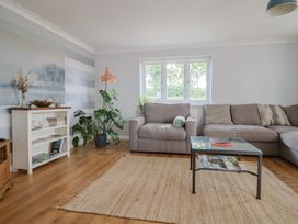 A living room with a couch, coffee table, and plants at Rainbow View, Churchstanton near Churchinford